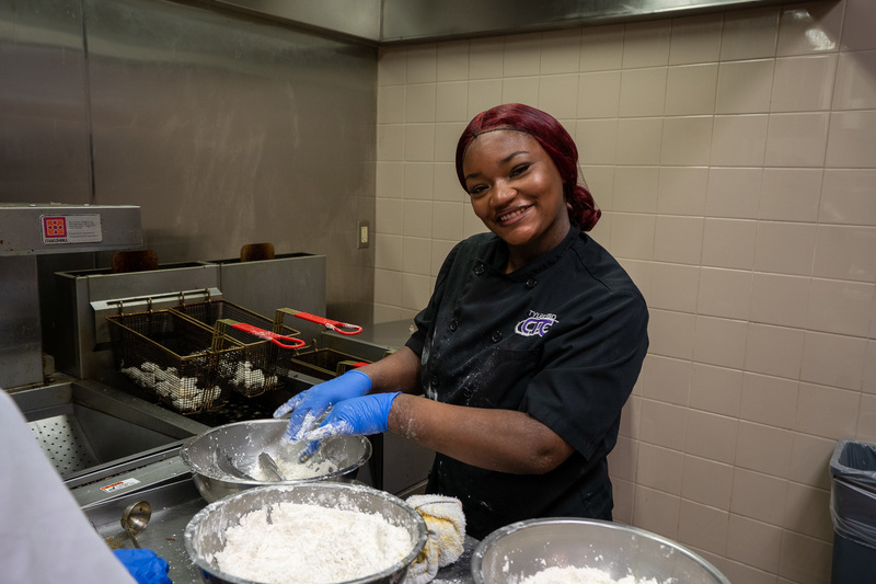 teen girl with hands in flour in kitchen