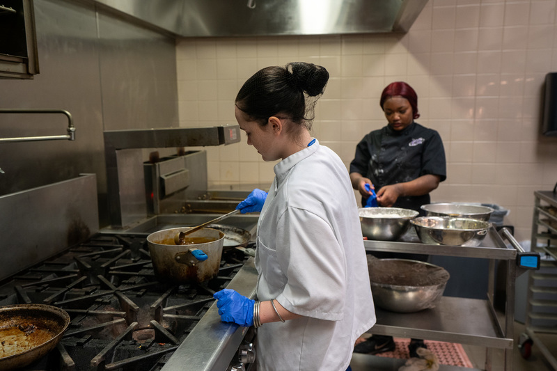high school students preparing lunch in kitchen