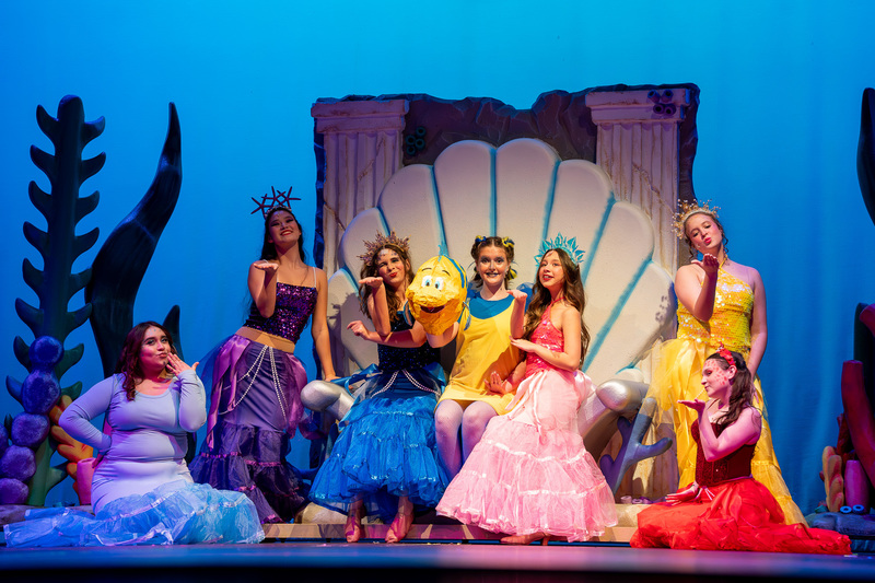 teens on stage in Little Mermaid costumes for perfomance