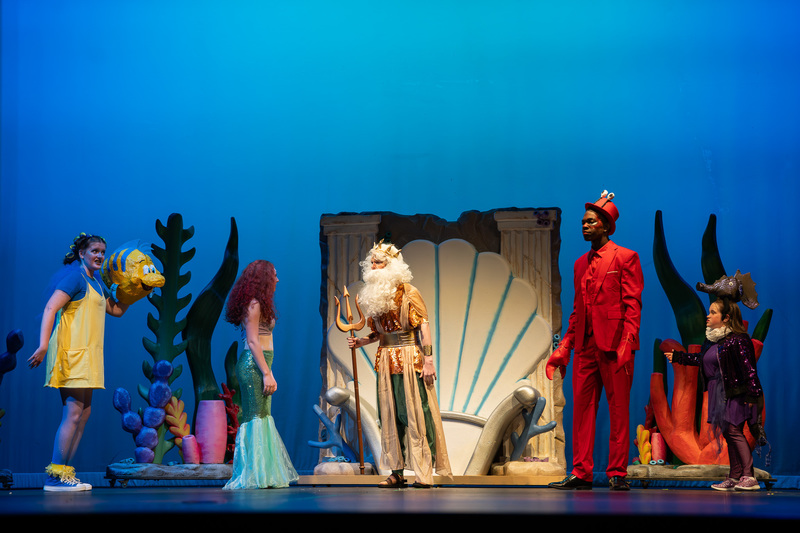 teens on stage performing "The Little Mermaid Jr."