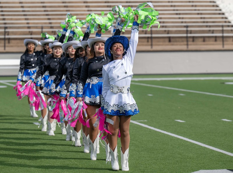 drill teams in uniform on football field 