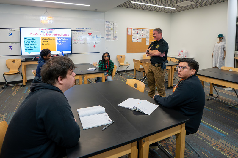 man talking to students in classroom