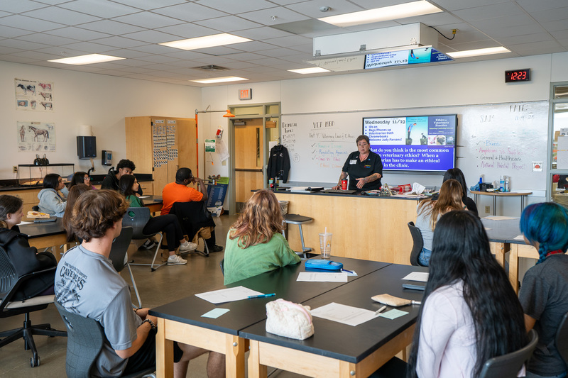 woman talking to students in classroom