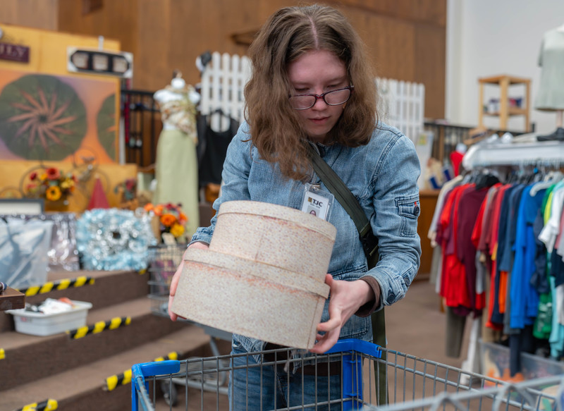 teen girl holding boxes