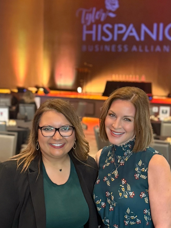 two women wearing green