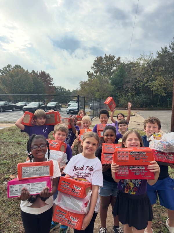 elementary age kids carrying boxes of noodles