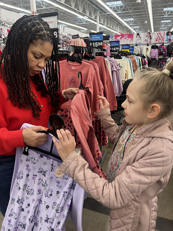 woman and young girl shopping for clothes