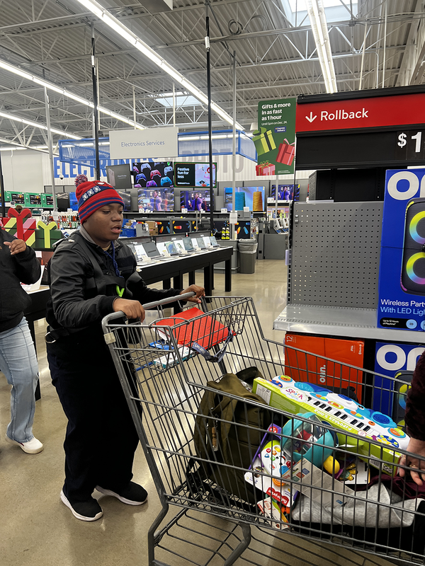 teen boy pushing shopping cart in store