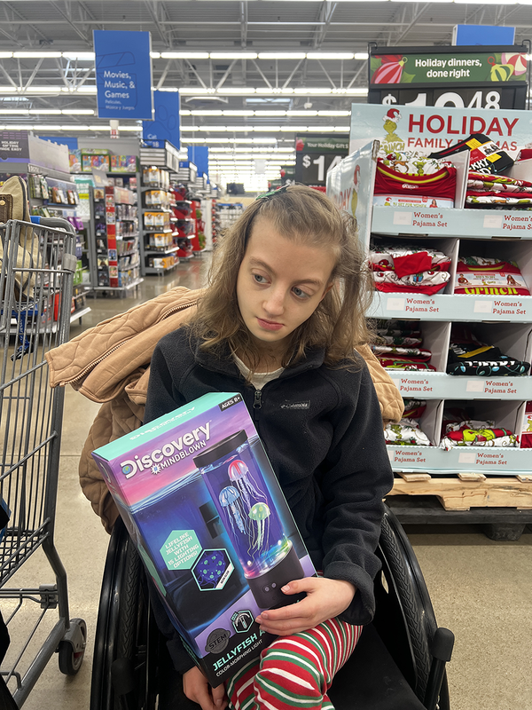 teen girl holding lava lamp in store