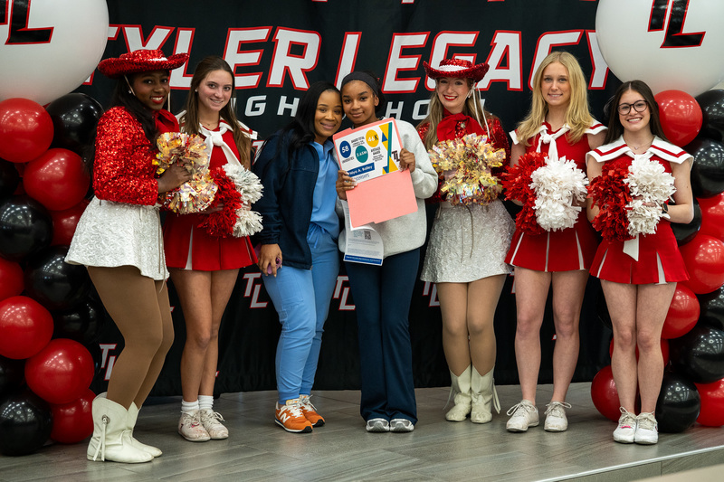 Tyler Legacy student celebrates VU Scholarship opportunities with Legacy Cheerleaders and Drill Team.