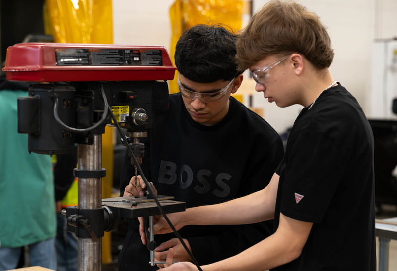 two teen boys working in shop class