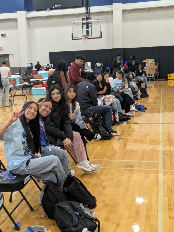 teens sitting in chairs waiting to donate blood