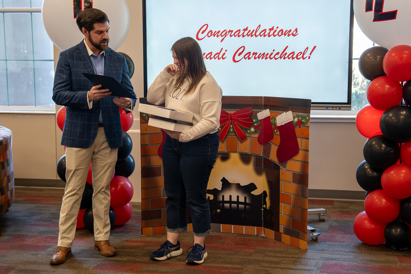 man handing teen girl a box
