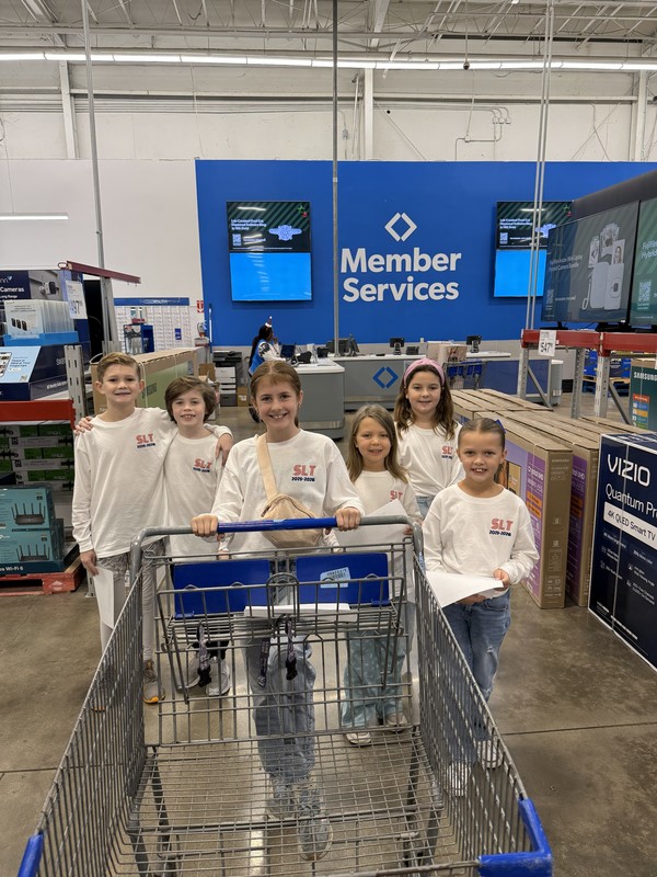 elementary kids with shopping cart in store