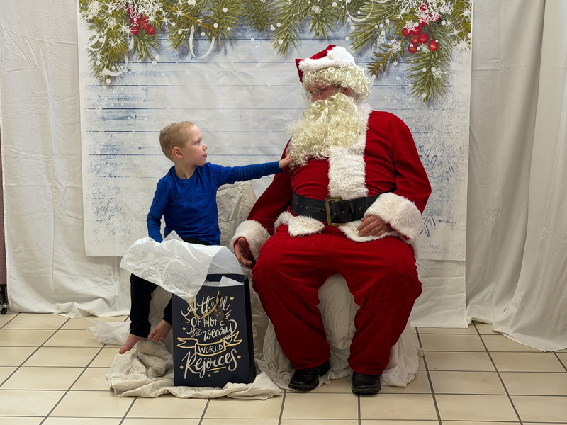 young boy talking to Santa