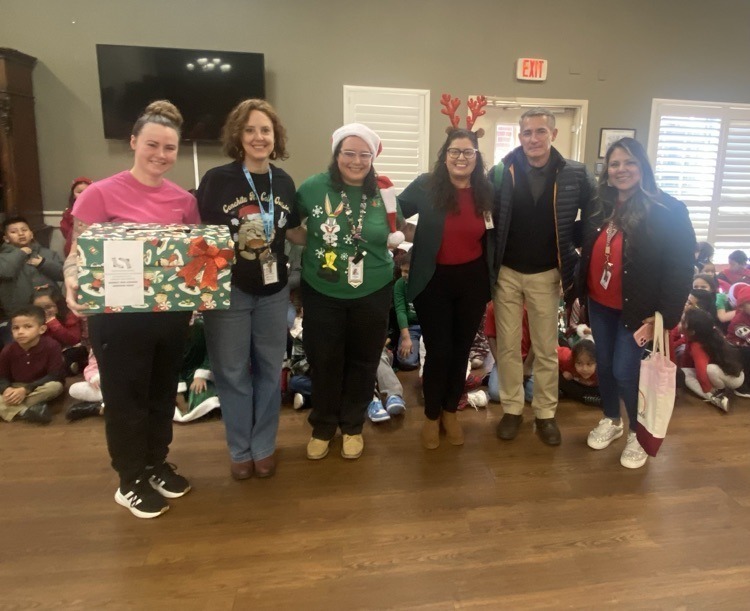 adults in Christmas outfits at nursing home