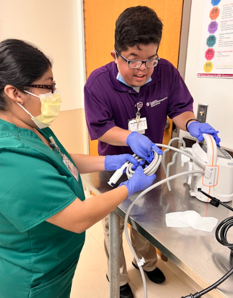 two people working with an IV pump