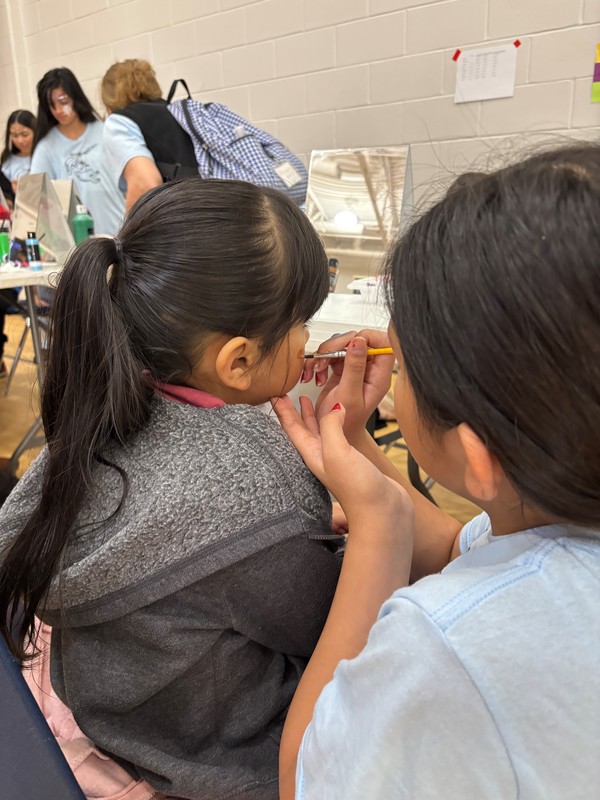 young child getting her face painted