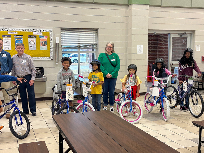 kids on bikes wearing helmets