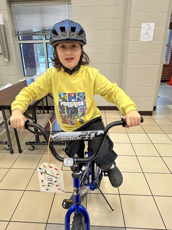 boy on bike wearing helmet