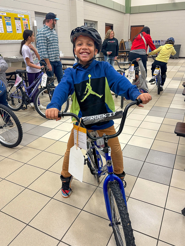 boy on bike wearing helmet