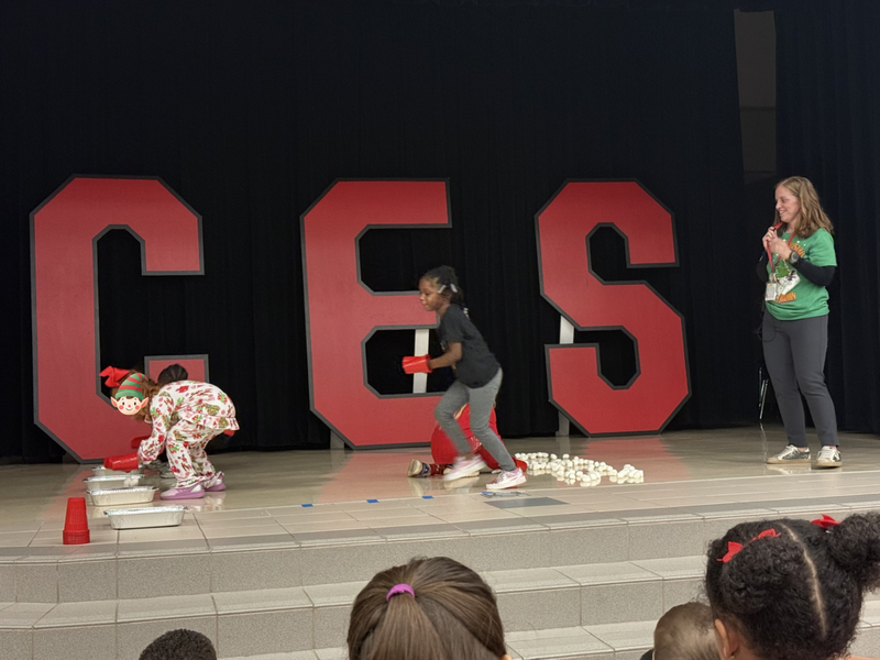 students standin on the stage with mrs. cureton our principal 