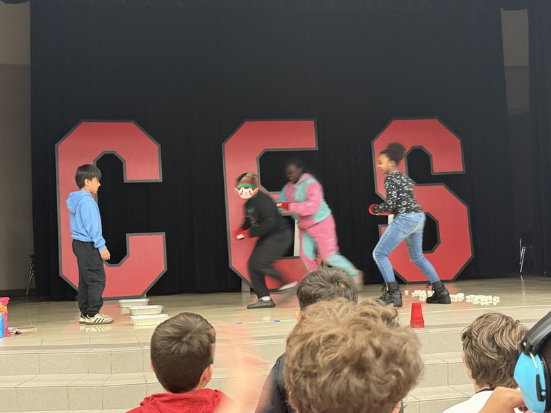 students standin on the stage with mrs. cureton our principal 