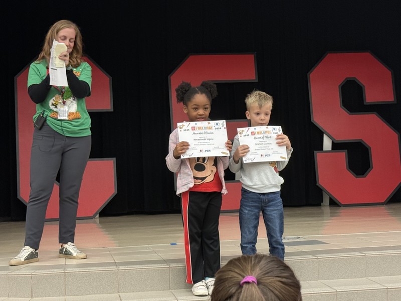 students standin on the stage with mrs. cureton our principal 
