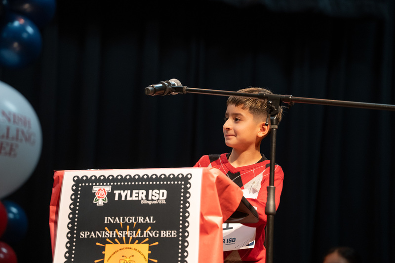 elementary age boy at podium with microphone