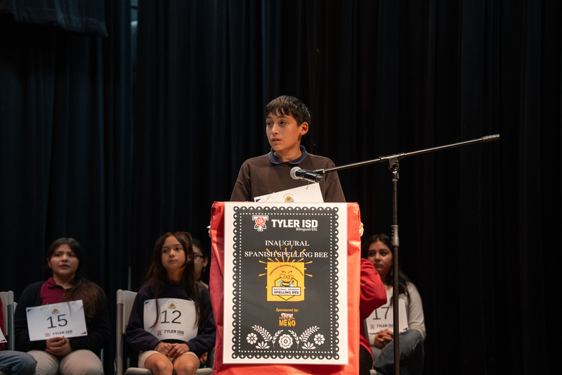 elementary age boy at podium with microphone