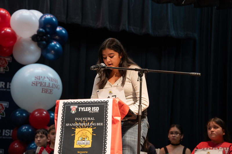 teen girl at podium with microphone