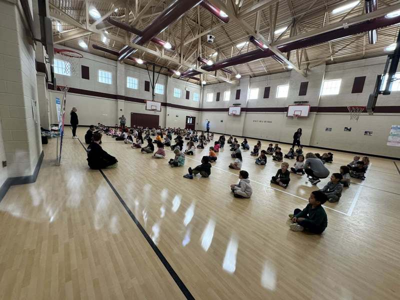Students in the gym following instructor