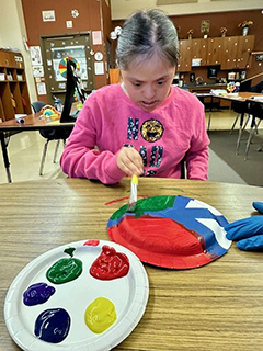 Special Needs Student creating a "Peace Plate" for MLK day
