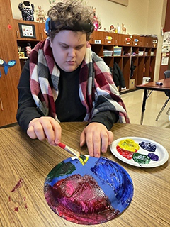 Special Needs Student creating a "Peace Plate" for MLK day