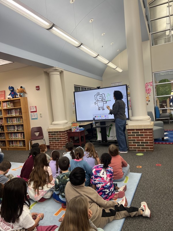 Anna raff drawing for a class of students