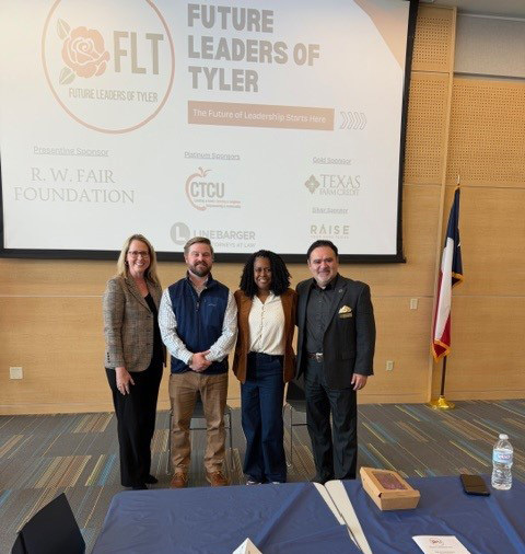 men and women stadning next to each other in front of a room