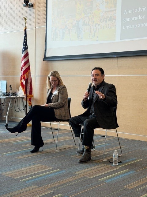 man and woman sitting in chairs in front of room