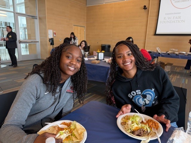 teen girls with their lunch at a table