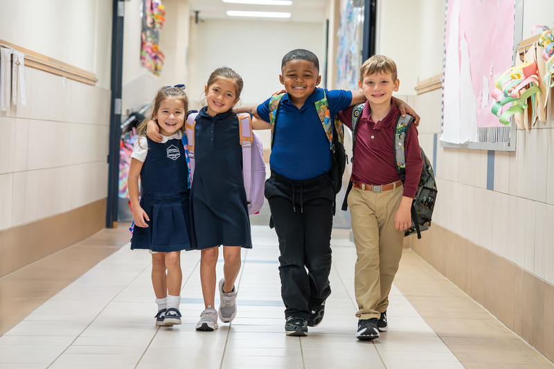 elementary age kids walking down a hallway