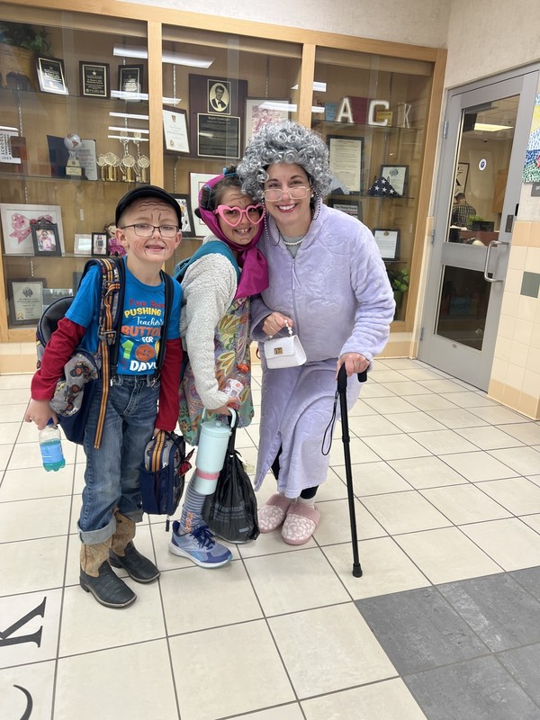 students with the principal dressed up as 100 year olds