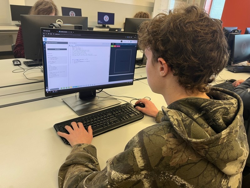 teen boy working on computer
