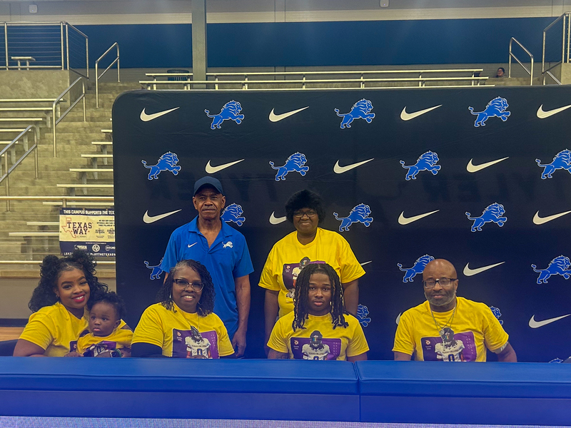 Davion Sirles smiles with family as he signs to play at Texas College
