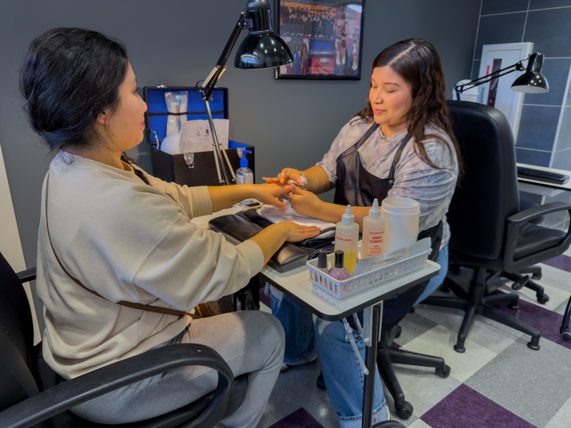 teen girl giving woman a manicure