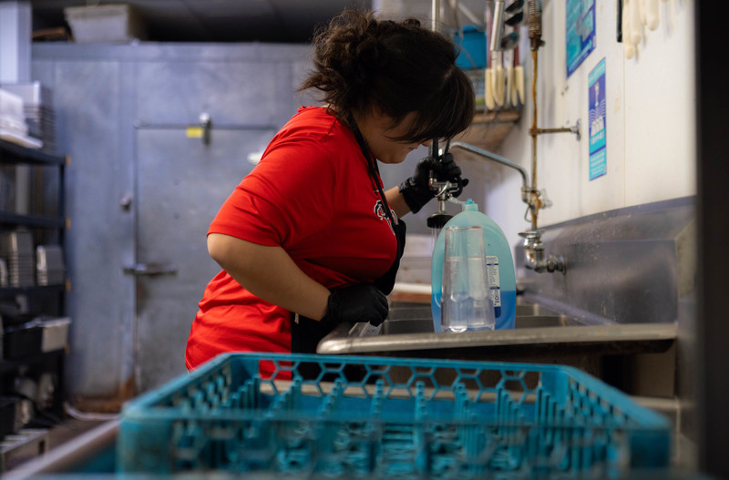 teen girl washing dishes