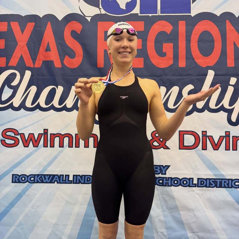 teen girl in swimsuit hodling gold medal