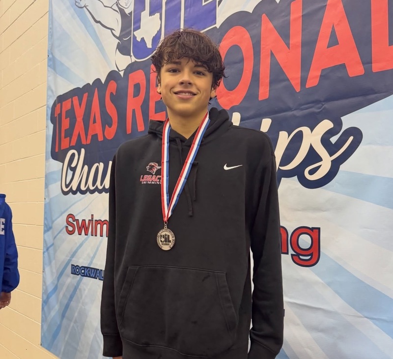 teen boy wearing black hoodie and medal around his neck