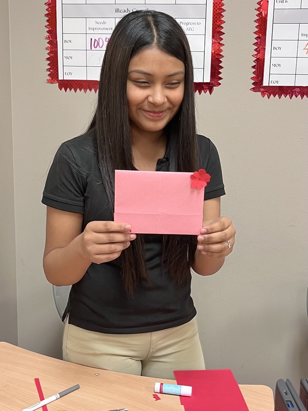 teen girl holding homemade Valentine card
