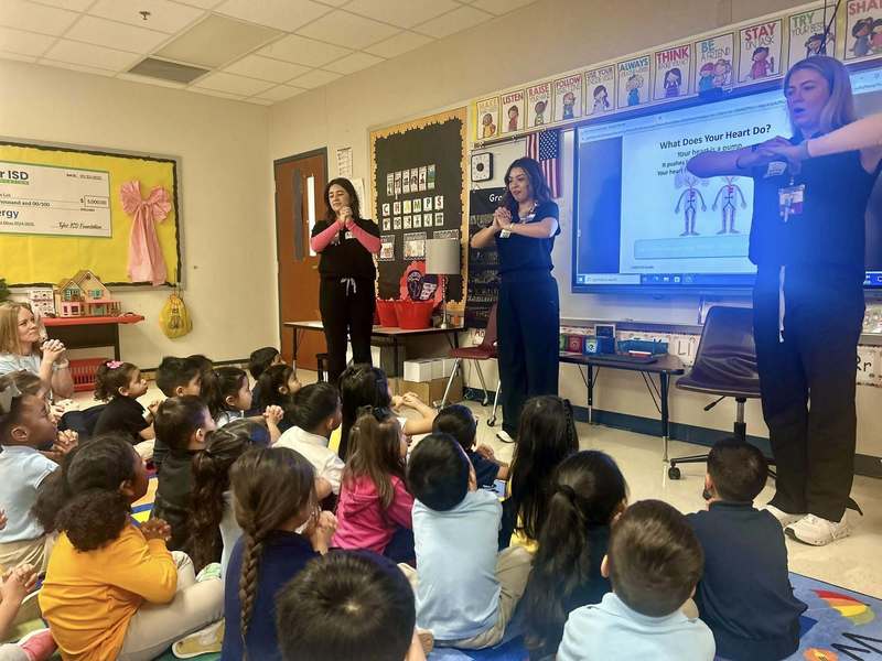 nurses talking to kids in classroom