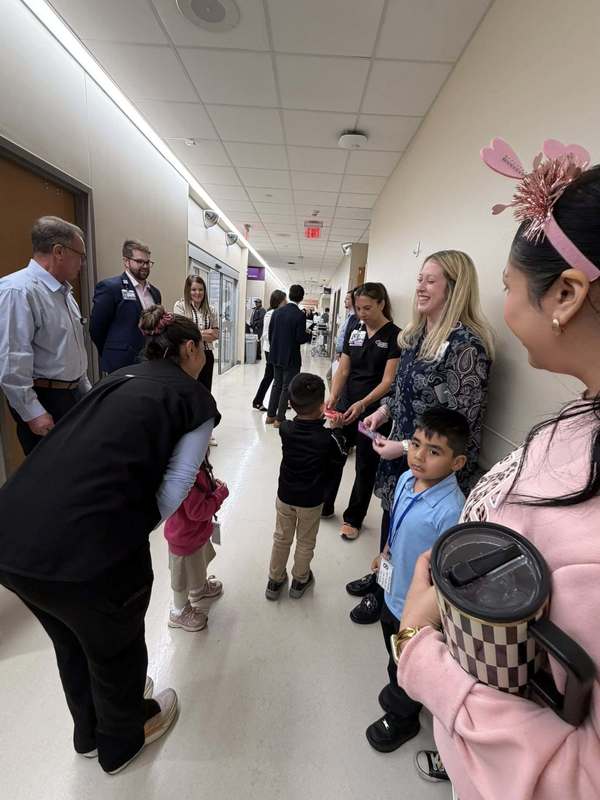 elementary age kids handing out Valentines in hallway