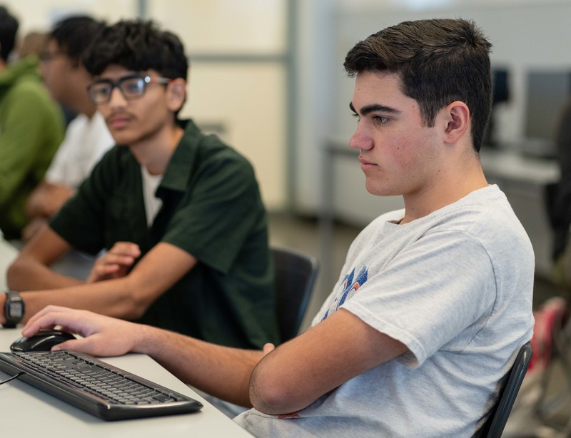 teen boys looking at computer